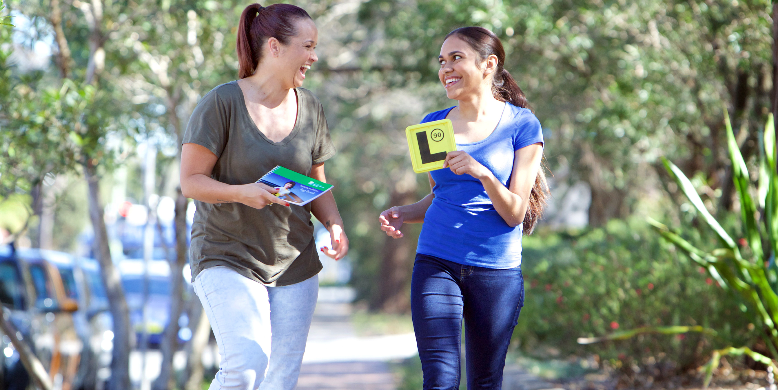 Two people walking with their L plates